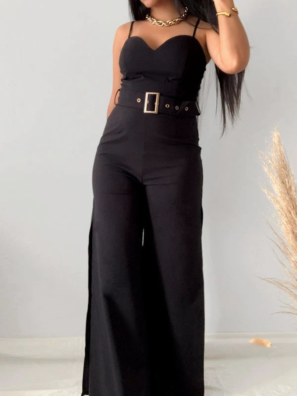 Woman wearing a belted black jumpsuit. 