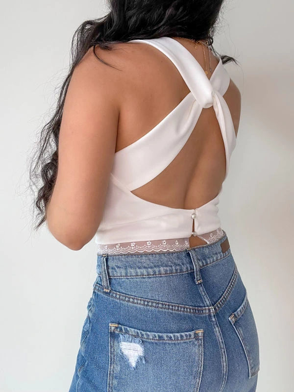 Back view of a fancy crop top in white. 