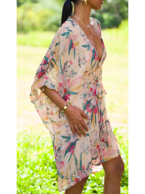 Side profile of a model, demonstrating the plunging neckline and flow of the kimono inspired dress with its distinctive kimono sleeves.
