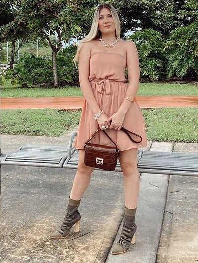 Woman in a peach Strapless Summer Dress outdoors.