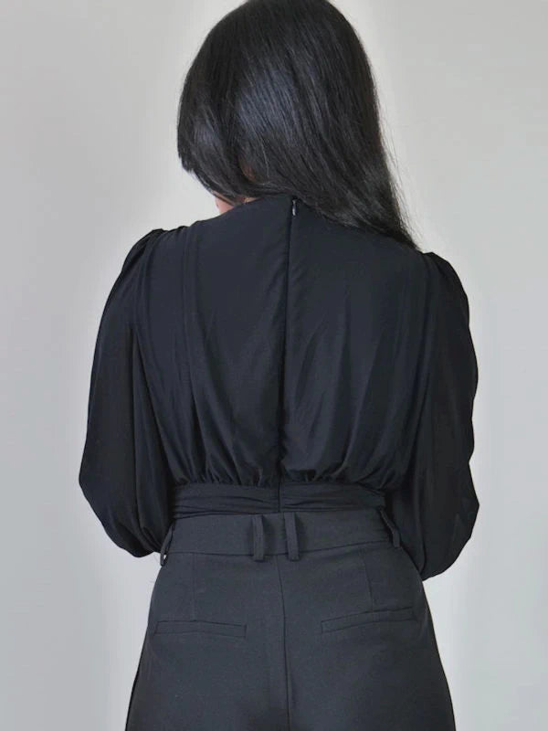 Back view of our black long sleeve bodysuit with zipper for women. 