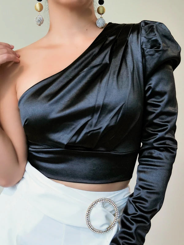 Image of a satin one shoulder top in black for women. 