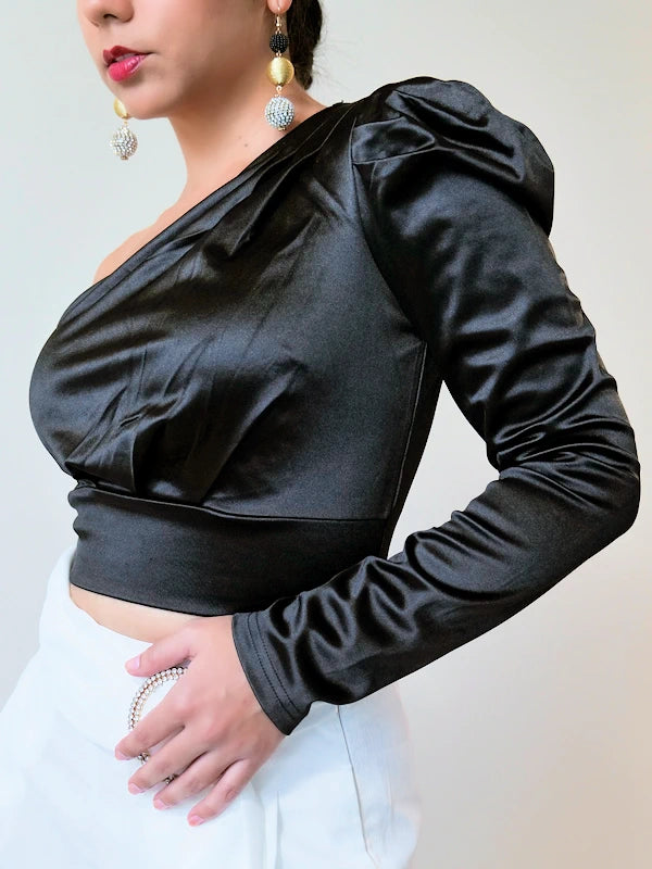 Woman wearing a black formal crop top with white pants. 