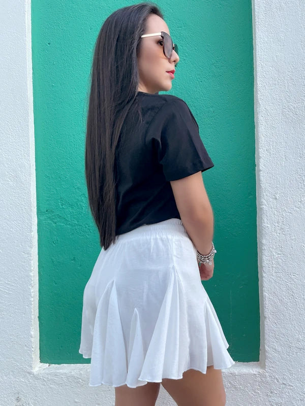 Back view of an asymmetrical skort in white. 